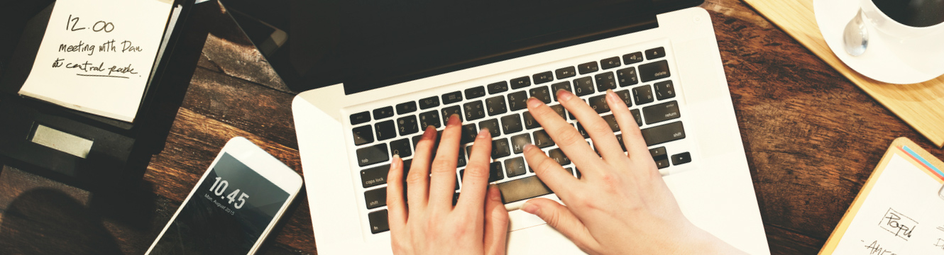 hands typing on a keyboard